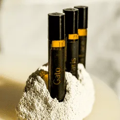 Three perfume vials in stone holder.