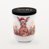 Smelty Christmas candle in a white ceramic jar with a black wooden lid and gold Smelty logo, printed with a young kangaroo in a Santa hat holding a large iced gingerbread star, surrounded by gingerbread men, cinnamon sticks and star anise.