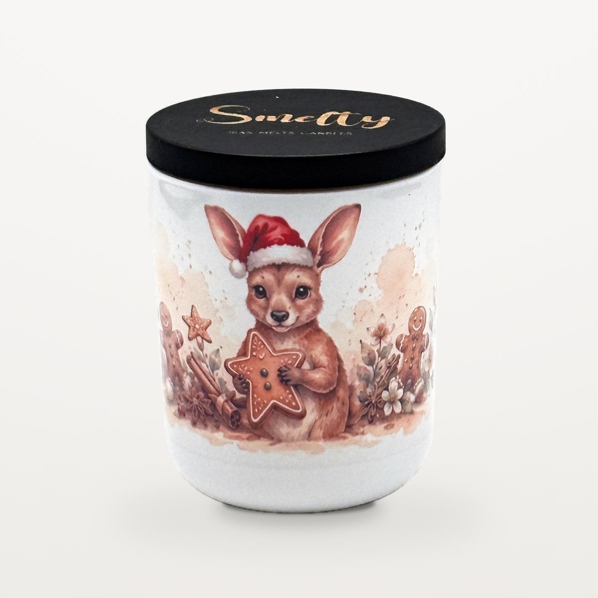 Kangaroo – Hansel &Amp; Gretel'S 1 Smelty Christmas Candle In A White Ceramic Jar With A Black Wooden Lid And Gold Smelty Logo, Printed With A Young Kangaroo In A Santa Hat Holding A Large Iced Gingerbread Star, Surrounded By Gingerbread Men, Cinnamon Sticks And Star Anise.