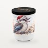 Kookaburra – Cinnamon &Amp; Orange 6 Smelty Christmas Candle In A White Ceramic Jar With A Black Wooden Lid And Gold Smelty Logo, Printed With A Laughing Kookaburra In A Santa Hat Perched On A Branch Among White Blossoms, Cinnamon Sticks And A Soft Watercolour Wash Of Orange Slices.