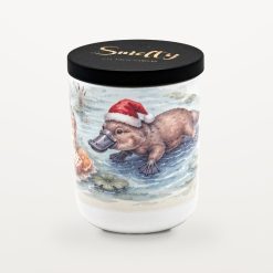 Smelty Christmas candle in a white ceramic jar with a black wooden lid and gold Smelty logo, printed with a platypus in a Santa hat paddling in a pond among lily pads and reeds.