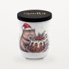 Smelty Christmas candle in a white ceramic jar with a black wooden lid and gold Smelty logo, printed with a smiling wombat in a Santa hat hugging a Christmas pudding topped with custard, holly and red berries.