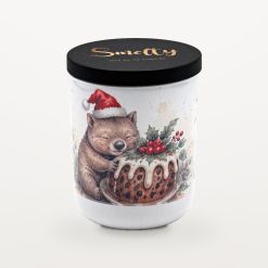 Smelty Christmas candle in a white ceramic jar with a black wooden lid and gold Smelty logo, printed with a smiling wombat in a Santa hat hugging a Christmas pudding topped with custard, holly and red berries.